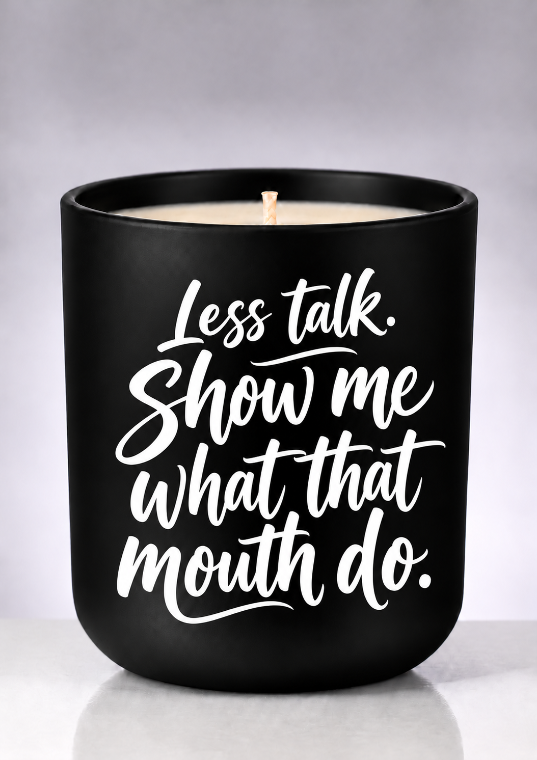Less Talk statement soy candle with white brush-script on a matte-black jar