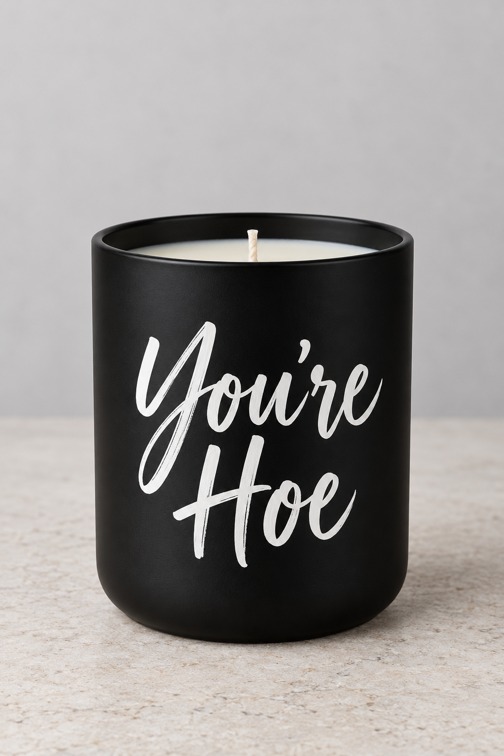 No Filter custom candle example showing You're Hoe in white script on a matte-black jar