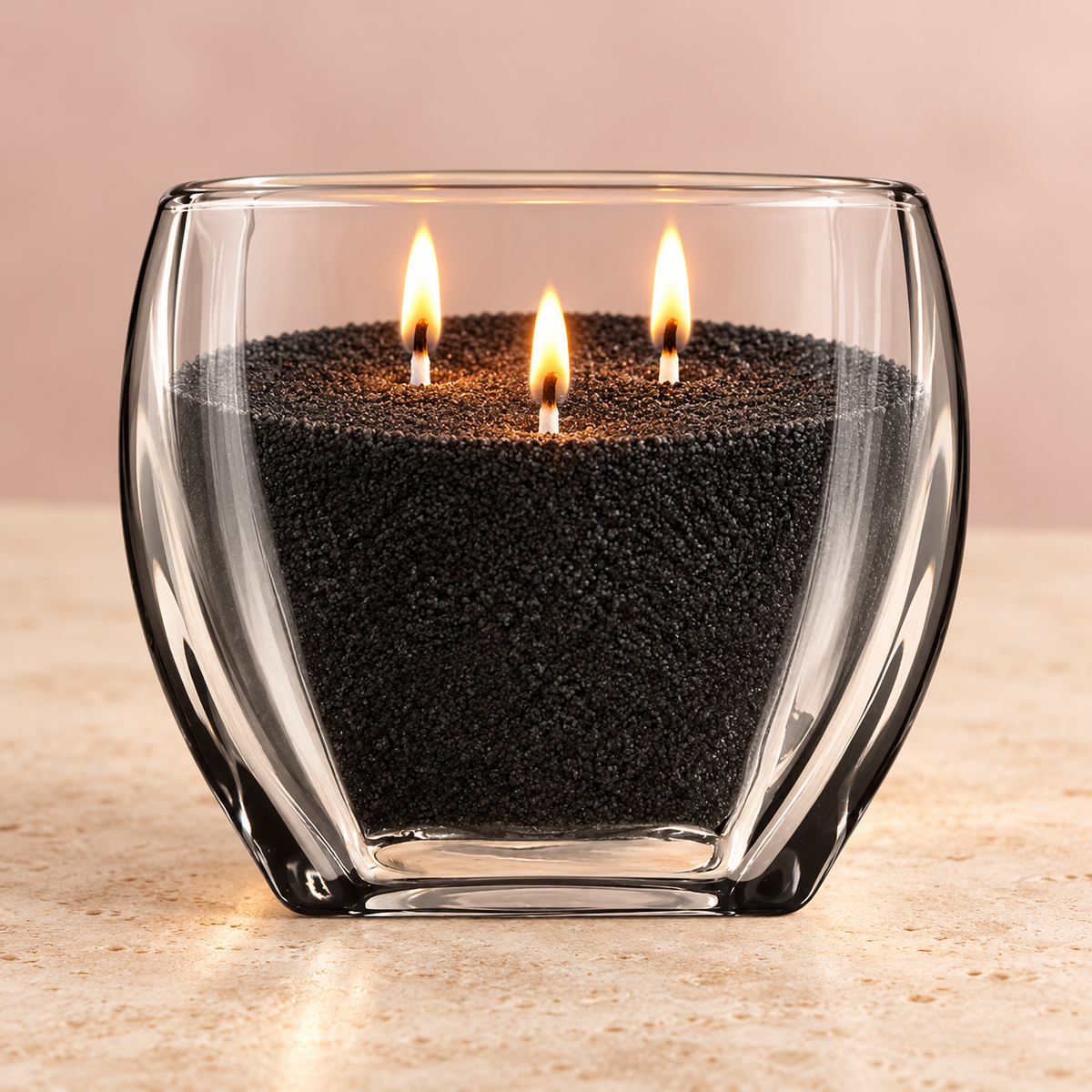 Ready to Glow glass vessel mockup filled with black wax sand and three lit white wicks