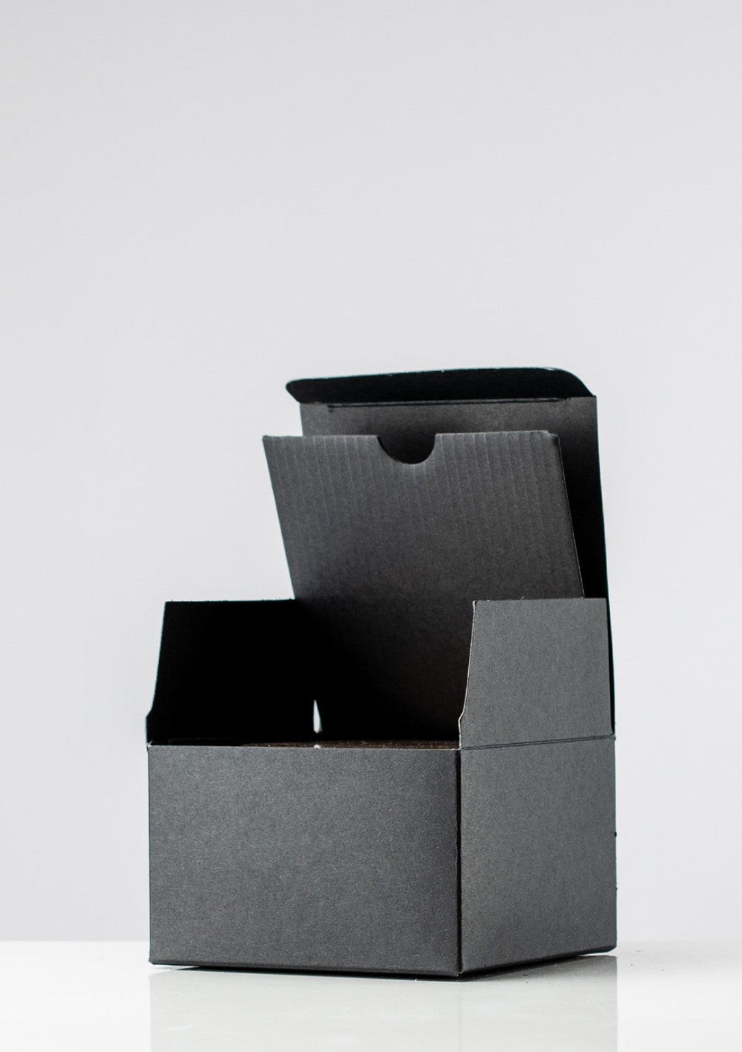 Open black candle presentation box